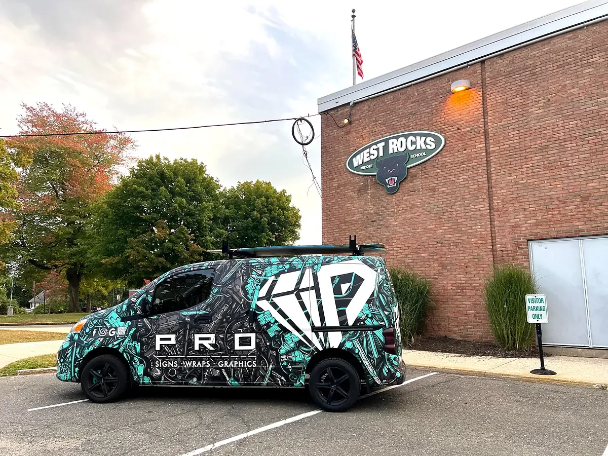 PRO Signs & Wraps van with school decals outside the Stamford shop