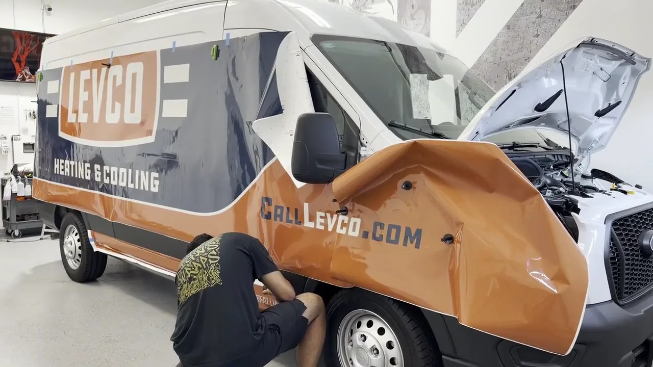 PRO Signs & Wraps shop — logo wall and large-format printer